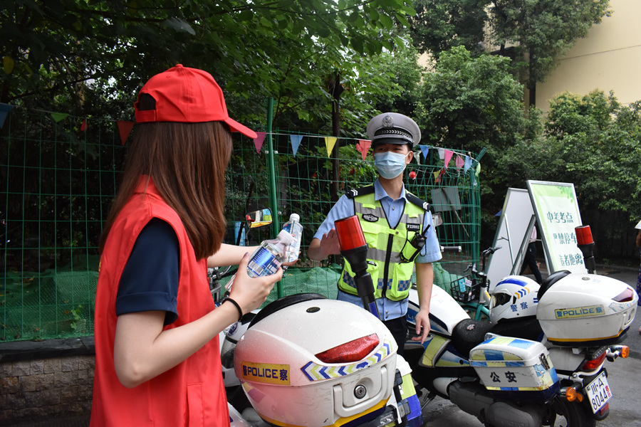 志愿者向现场执勤交警送上矿泉水.jpg